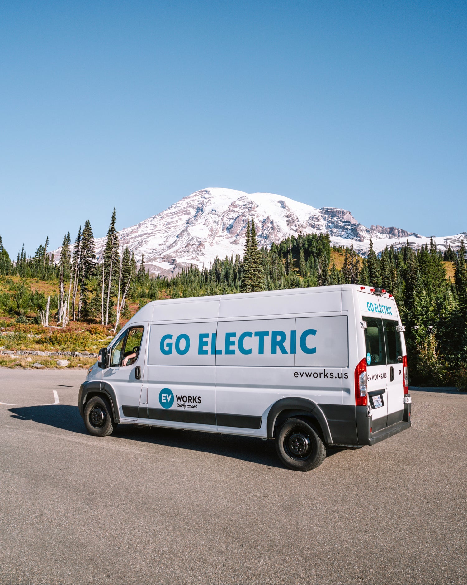 custom electric van next to mountain