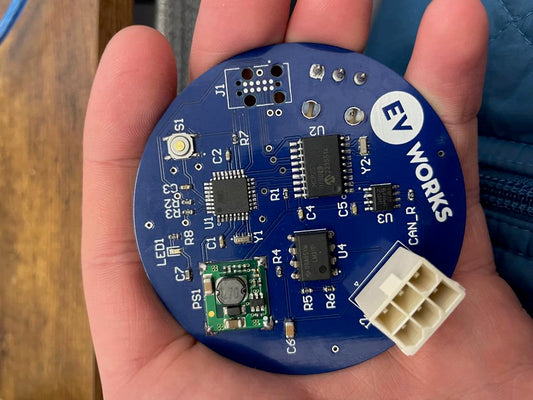 Blue circuit board held in palm of hand