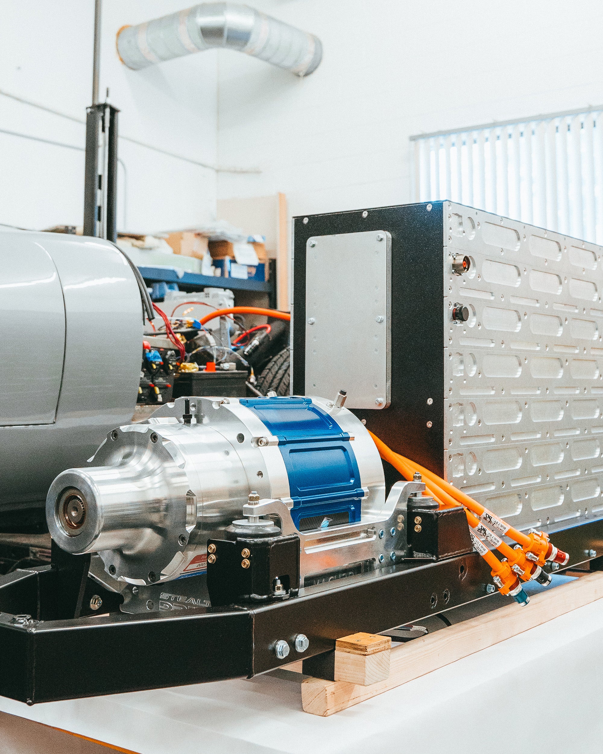 electric powertrain next to vehicle